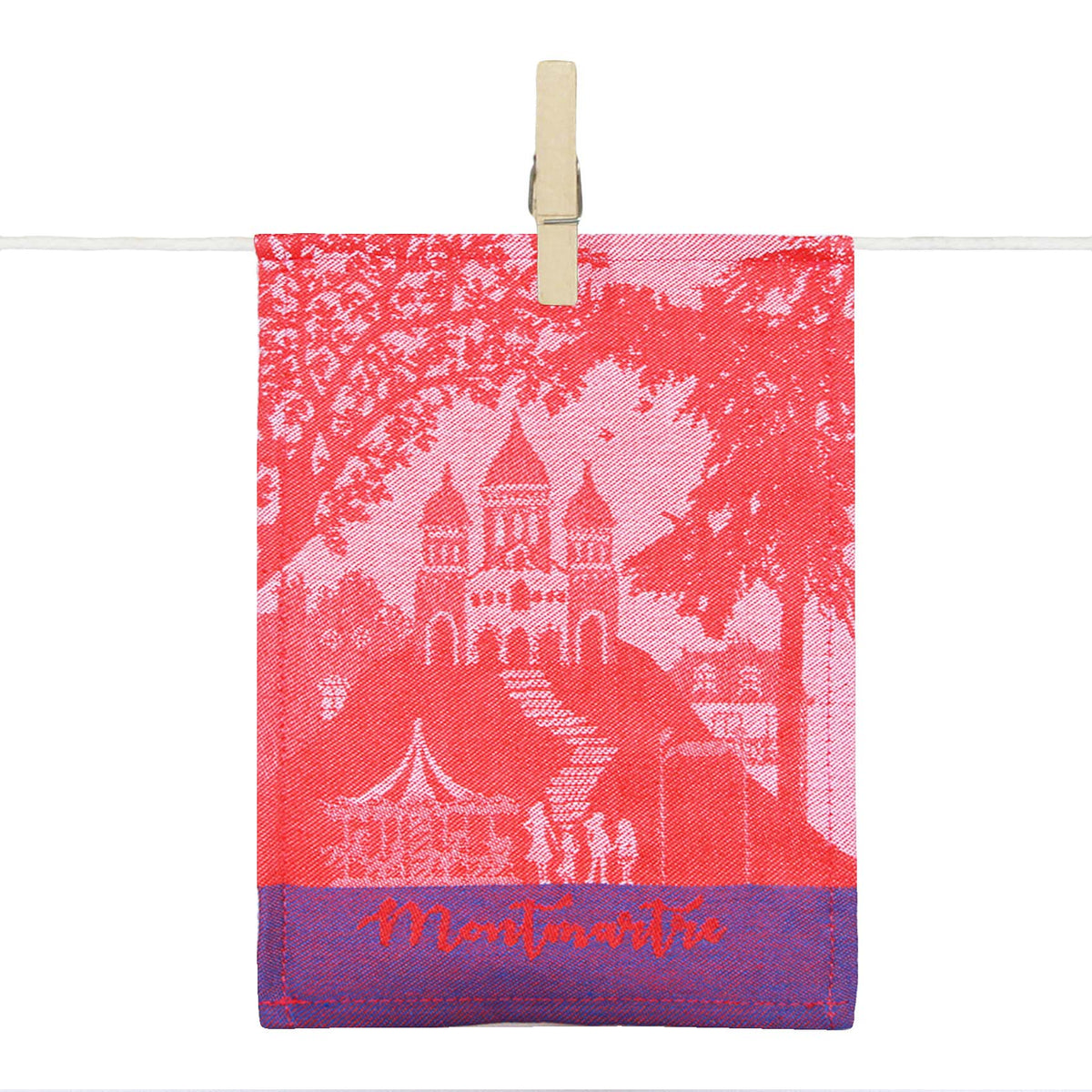 Para-tapas Montmartre en textile rose et violet, illustré de la Basilique du Sacré-Cœur et d’un carrousel, avec l’inscription « Montmartre ».