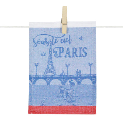 Porte-tapas « Sous le ciel de Paris » en textile bleu et blanc, illustré de la Tour Eiffel, d’un pont parisien et d’un cycliste, dans un esprit typiquement parisien.