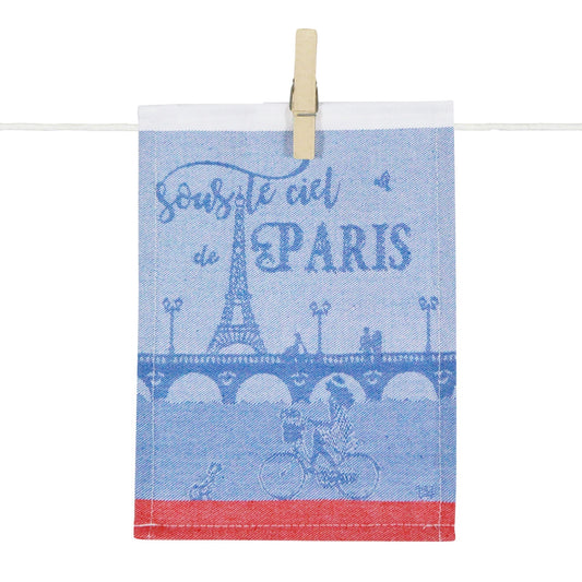 Porte-tapas « Sous le ciel de Paris » en textile bleu et blanc, illustré de la Tour Eiffel, d’un pont parisien et d’un cycliste, dans un esprit typiquement parisien.