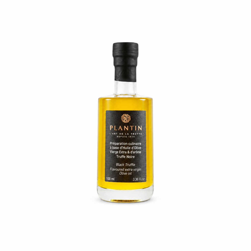 Bouteille de préparation culinaire Plantin à base d’huile d’olive vierge extra et d’arôme de truffe noire, format 100 ml. Présentée sur fond clair, la bouteille en verre met en valeur la couleur dorée de l’huile et l’étiquette noire signature de la Maison Plantin.